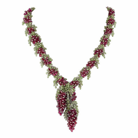 Medium length necklace with deep red Garnet grapes and green Peridot leaves along a chain with two large deep red grapes with green leaves hanging like a pendant in the centre.. 