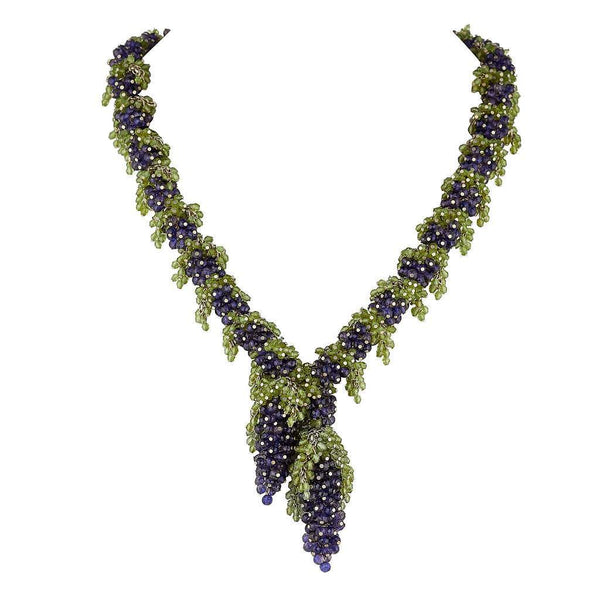 Medium length necklace with deep blue Iolite grapes and green Peridot leaves along a chain with two large deep blue grapes with green leaves hanging like a pendant in the centre.. 